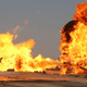 Oil workers and firemen try to extinguish flames at the Khabbaz oil field in Iraq.